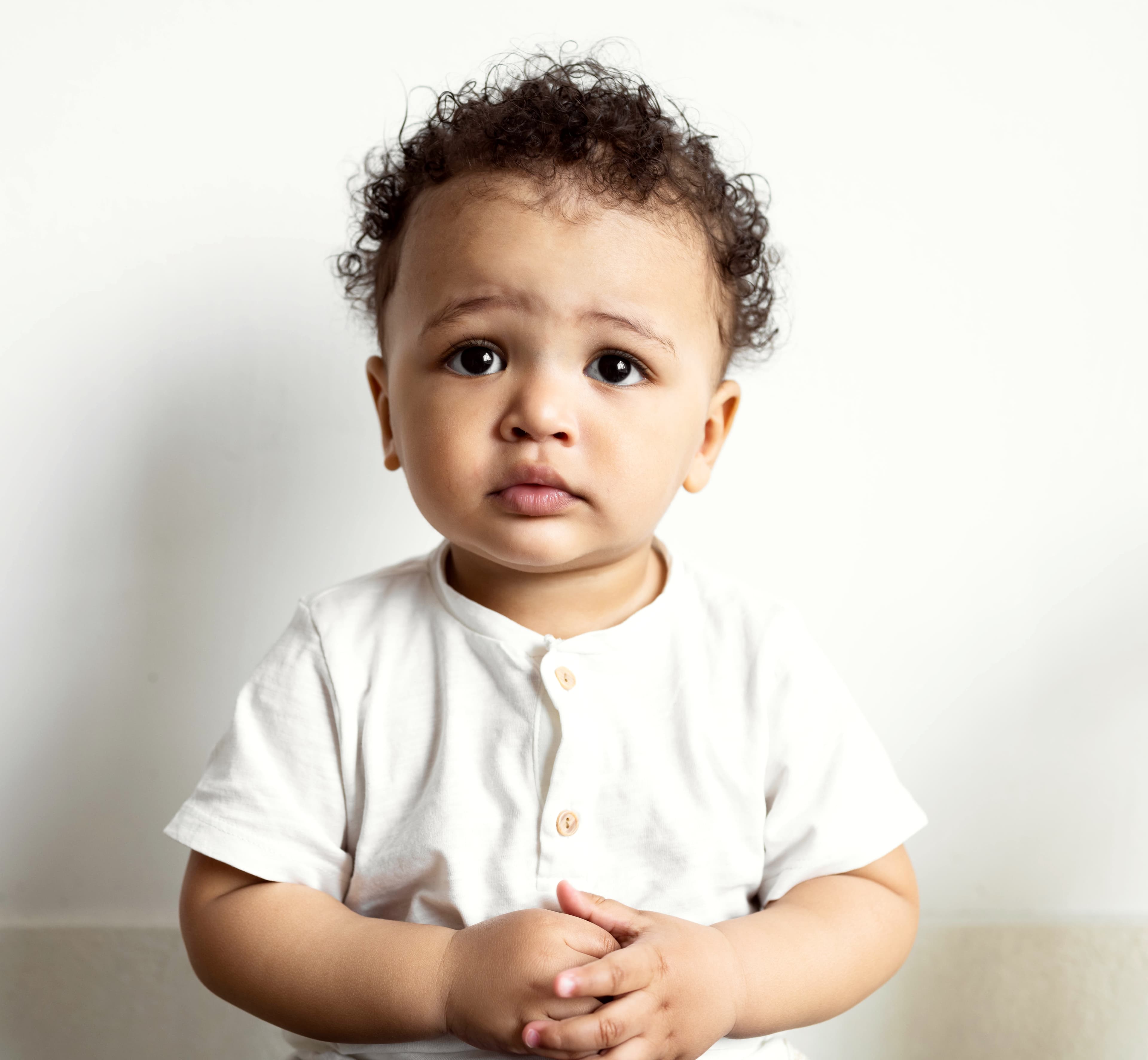 A toddler with curly hair