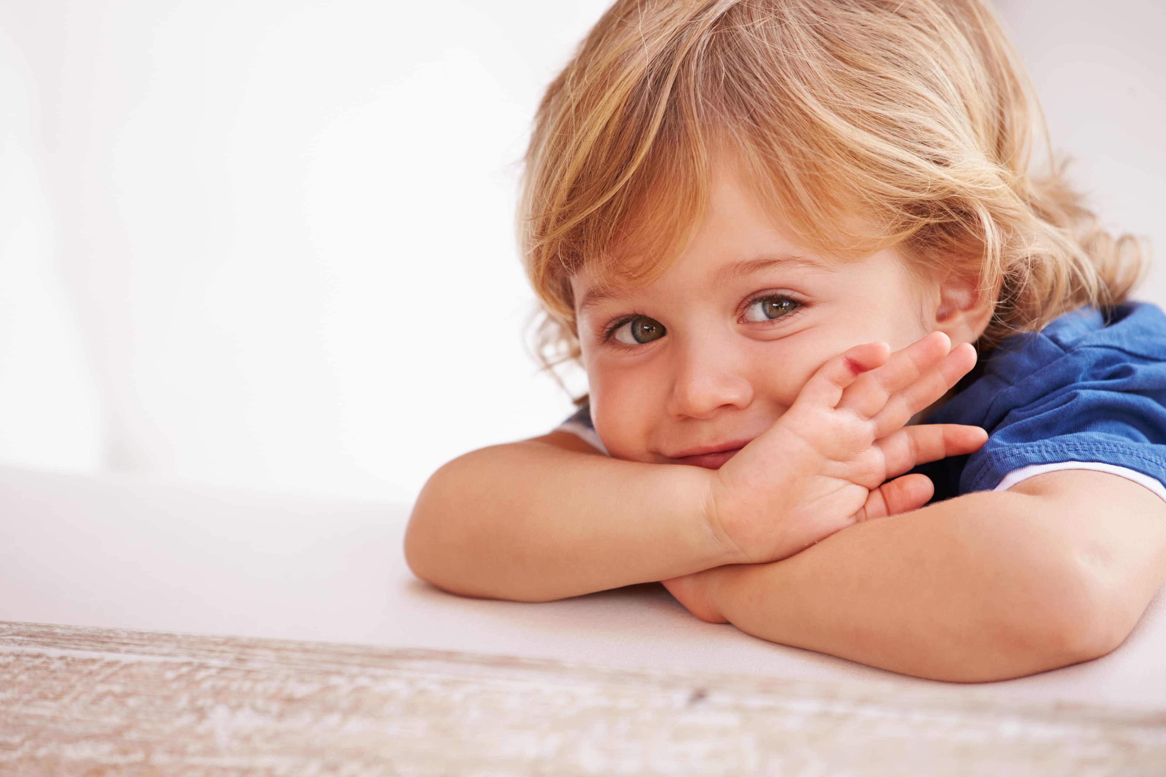 A child resting their head on their arms