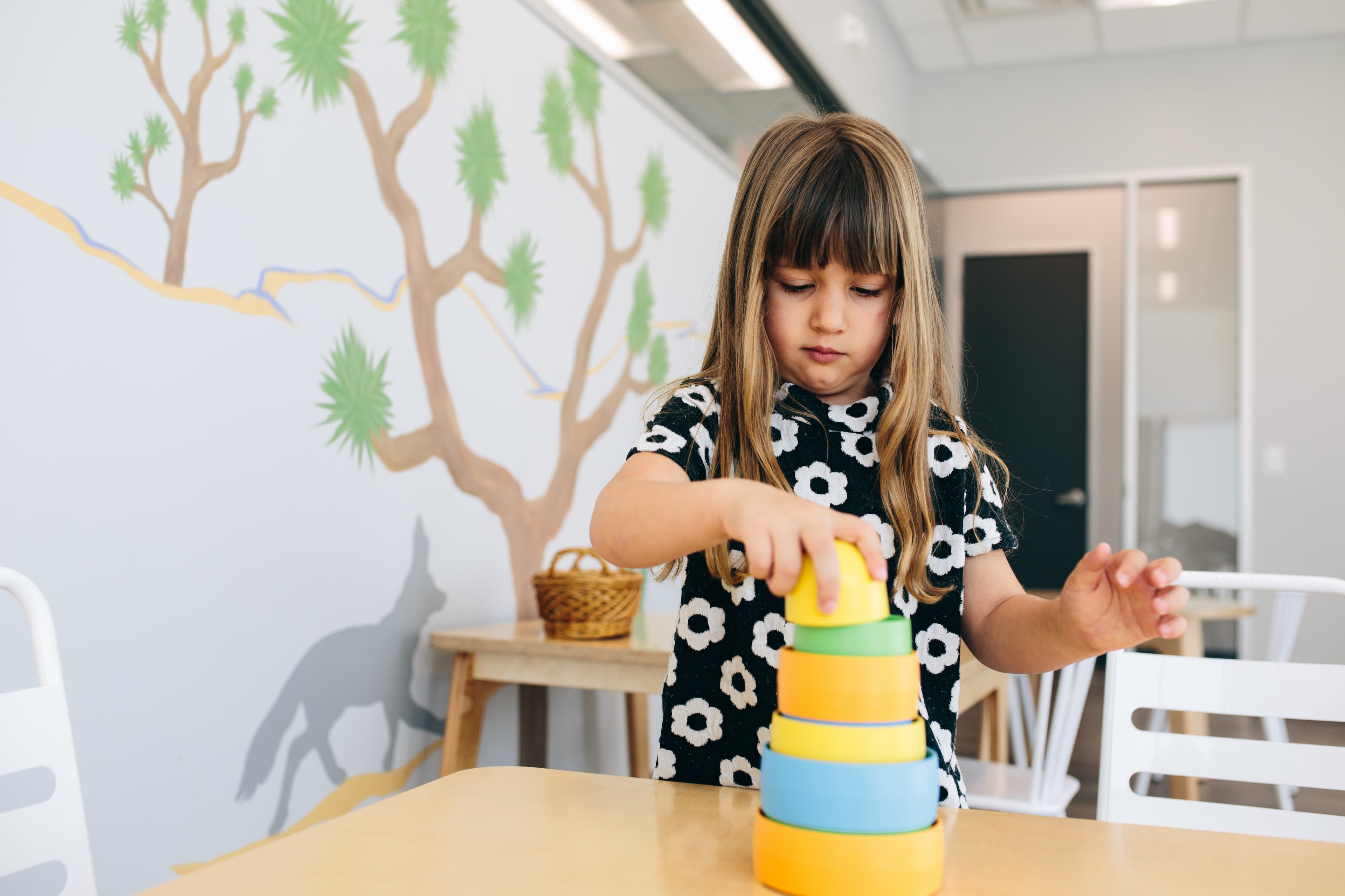 A child stacking blocks on a table