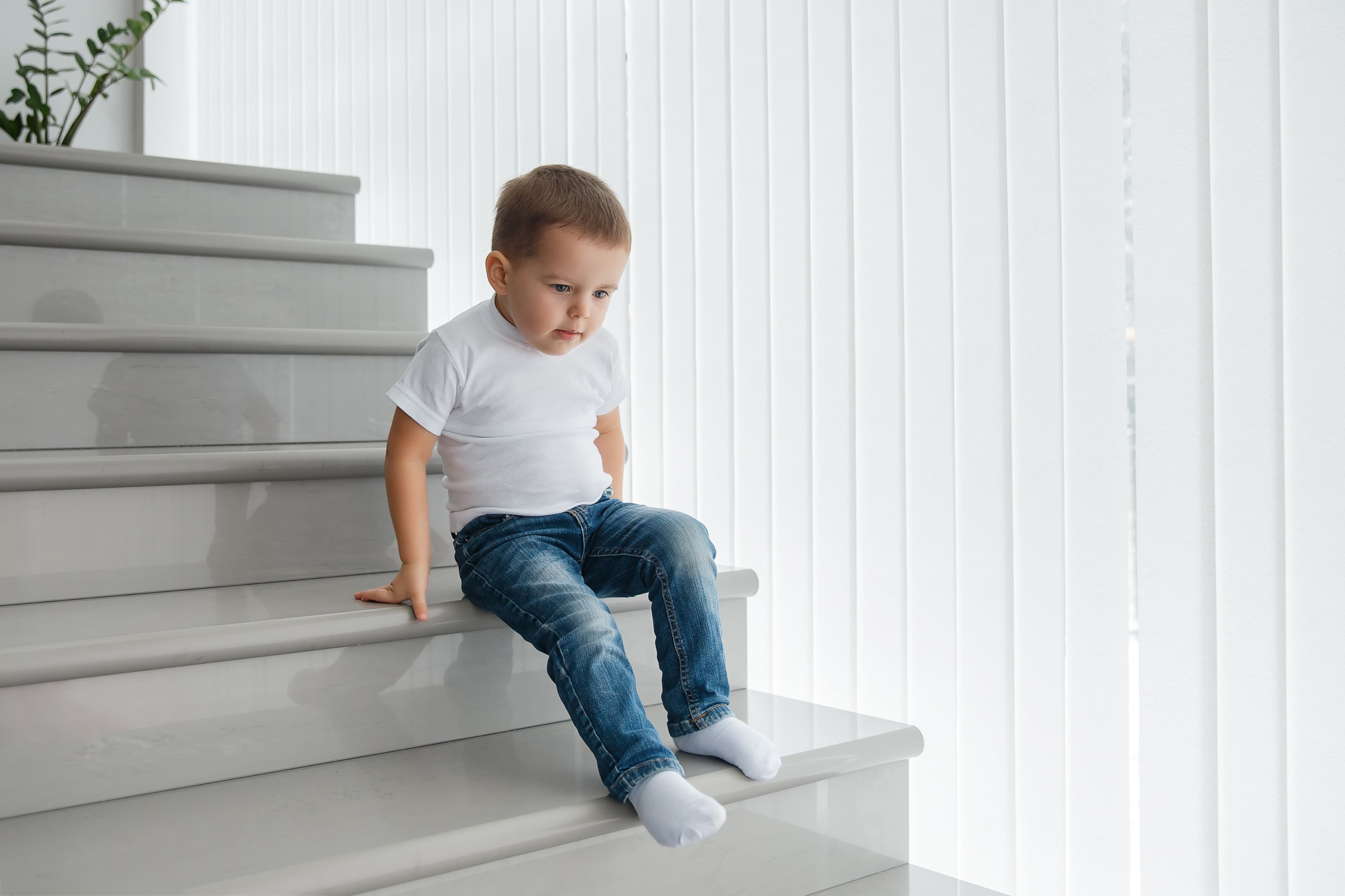 A child sliding down a staircase while seated