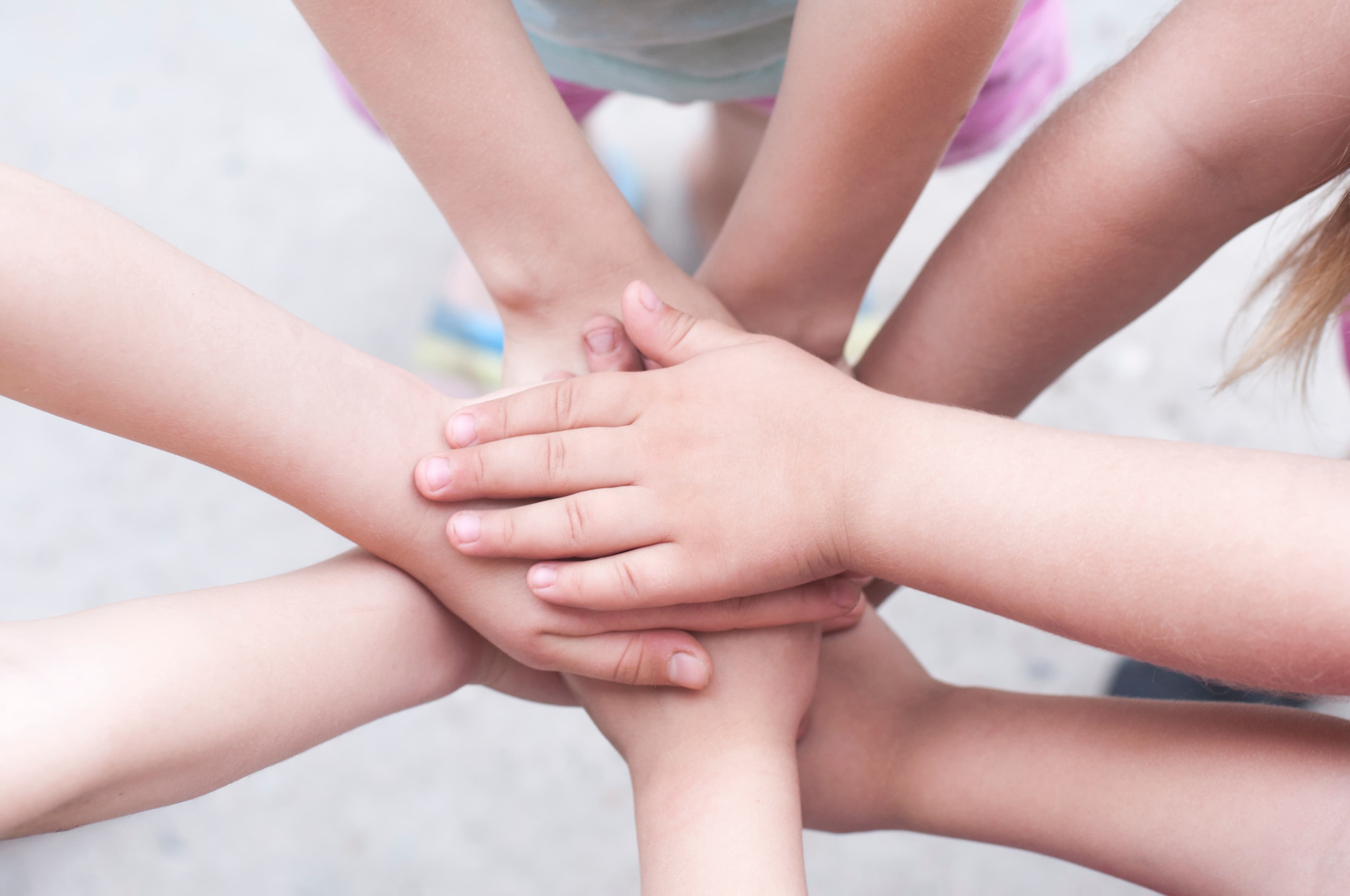 Childrens' hands in a huddle