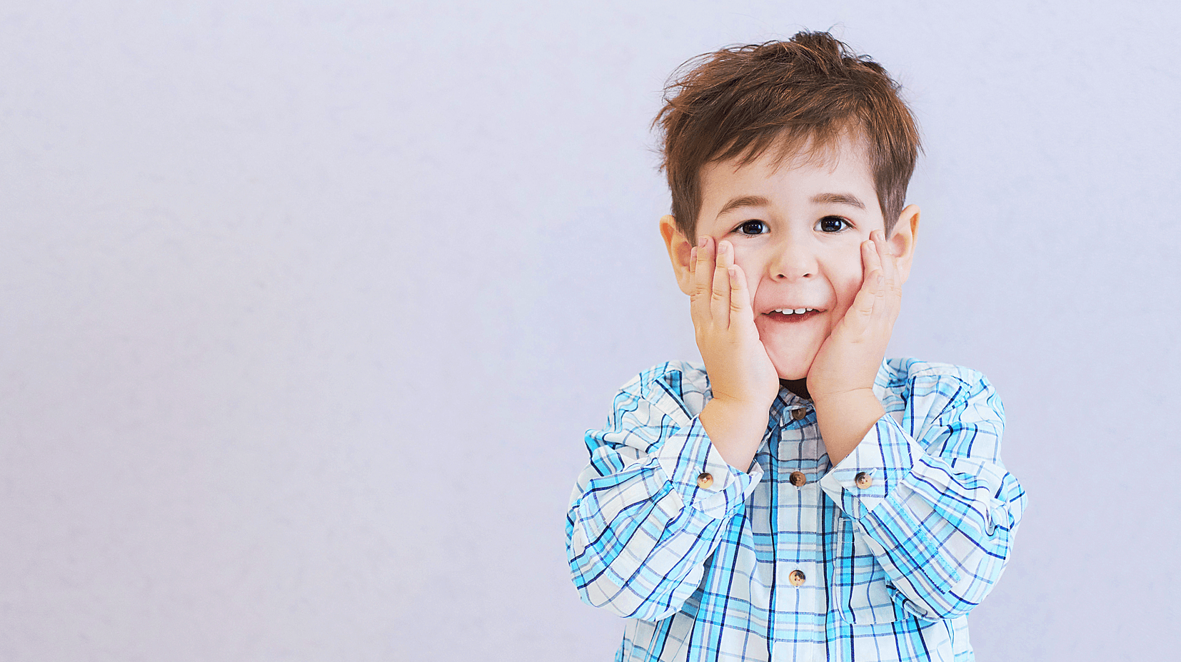 funny boy three years old hid his face in his hands