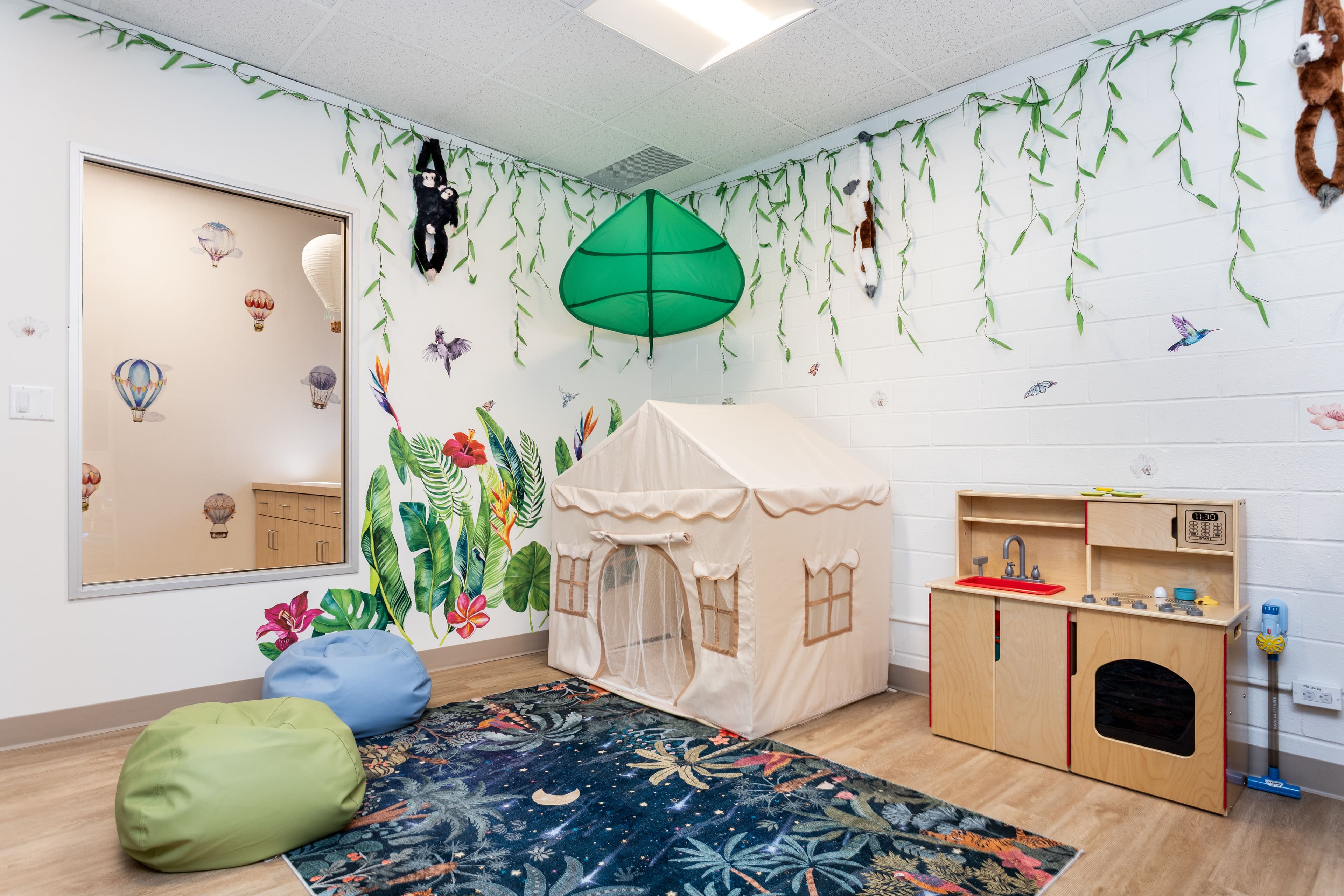 A play area with toys and stuffed animals neatly organized on shelves in the background