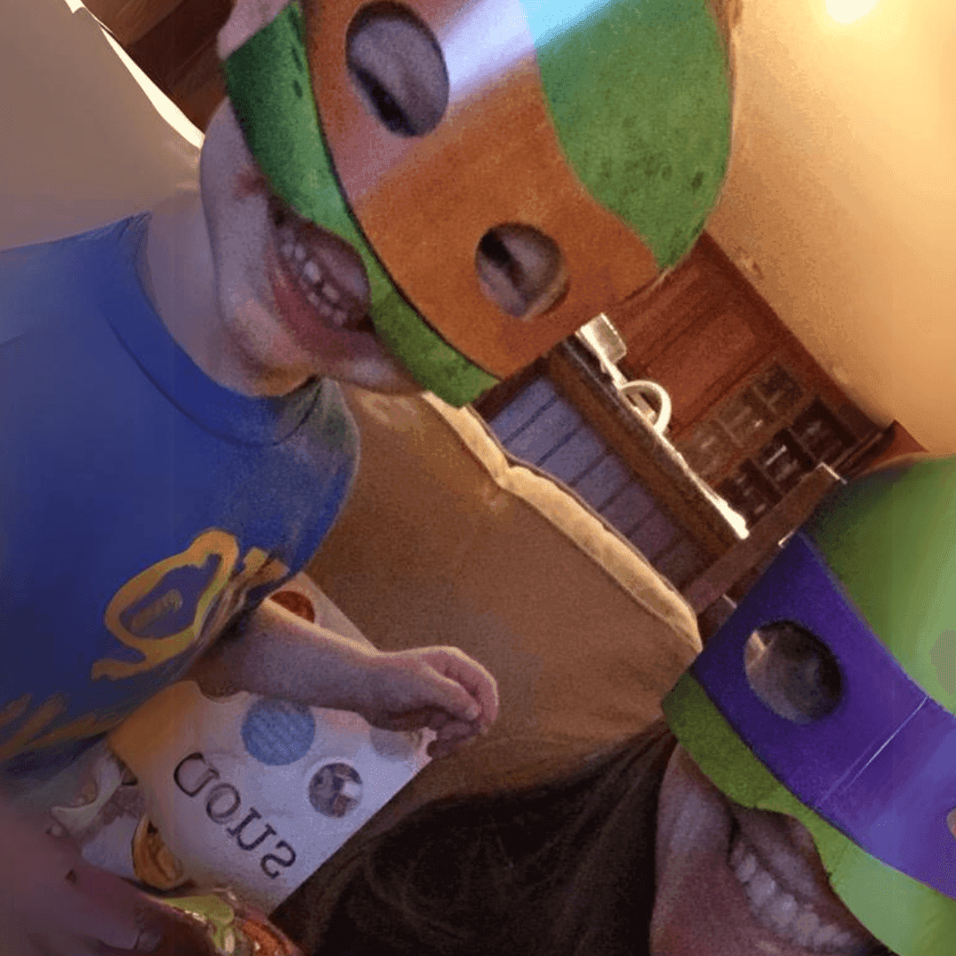 Walnut Creek Director Caitlin Holmes and child wearing teenage mutant ninja turtle masks