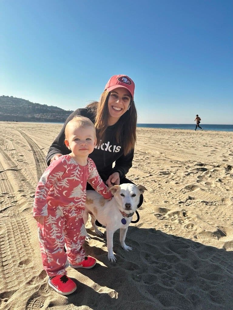 Redondo Beach Director Janine Strack with a child and dog on a beach 