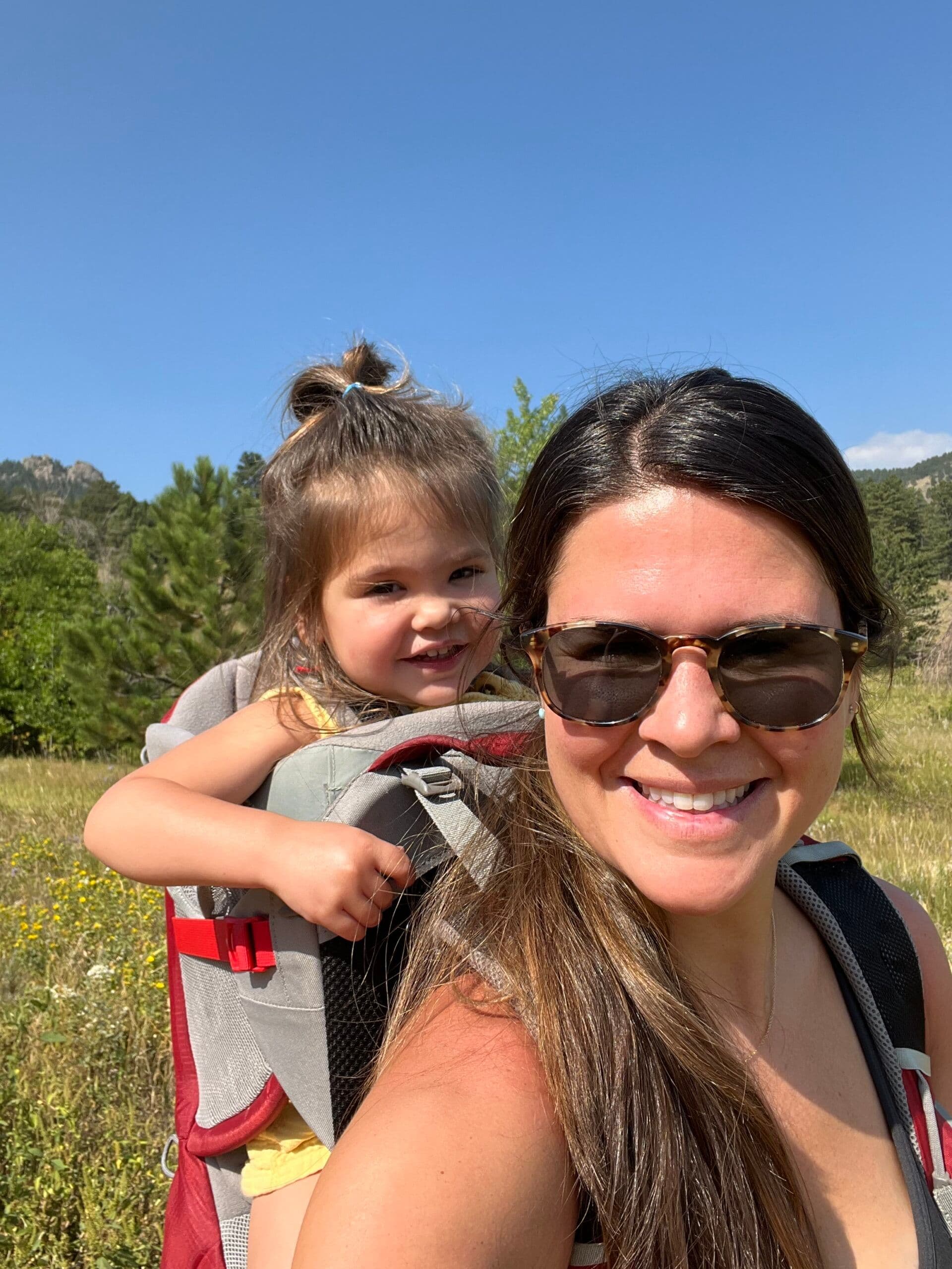 First Steps for Kids Director of Clinical Operations Jenna Battaglia carrying a child